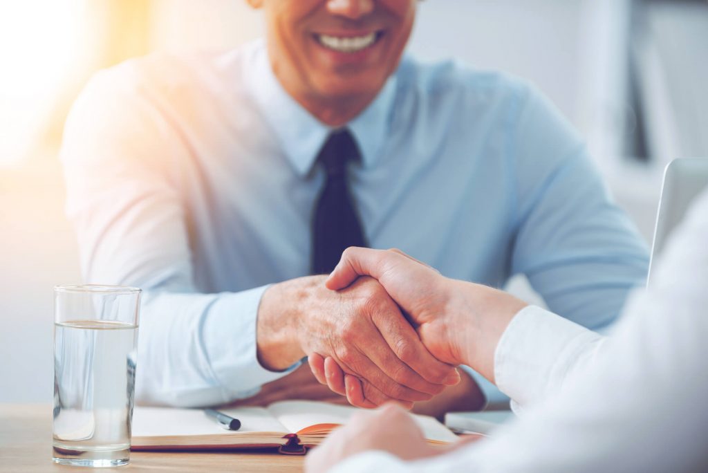 men shaking hands in medical practice hiring interview