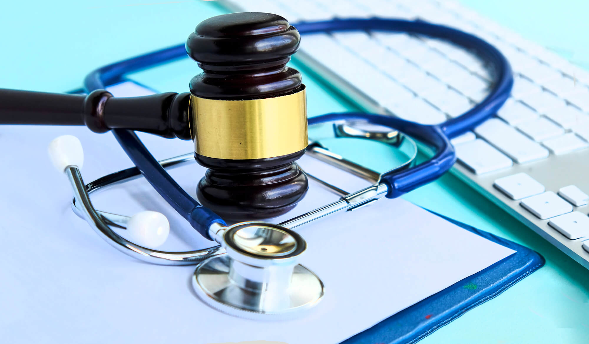 gavel and stethoscope on paperwork