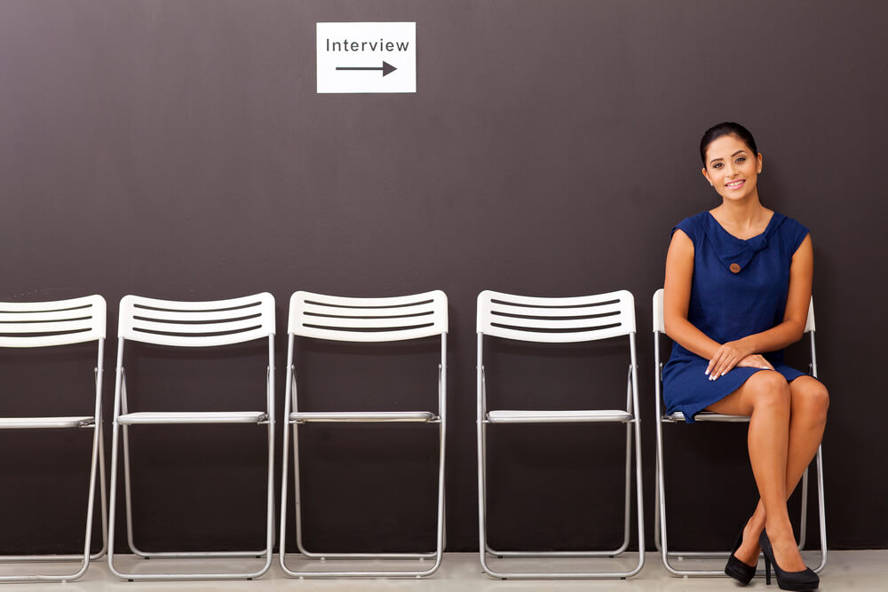 professional woman sitting in chair for interview
